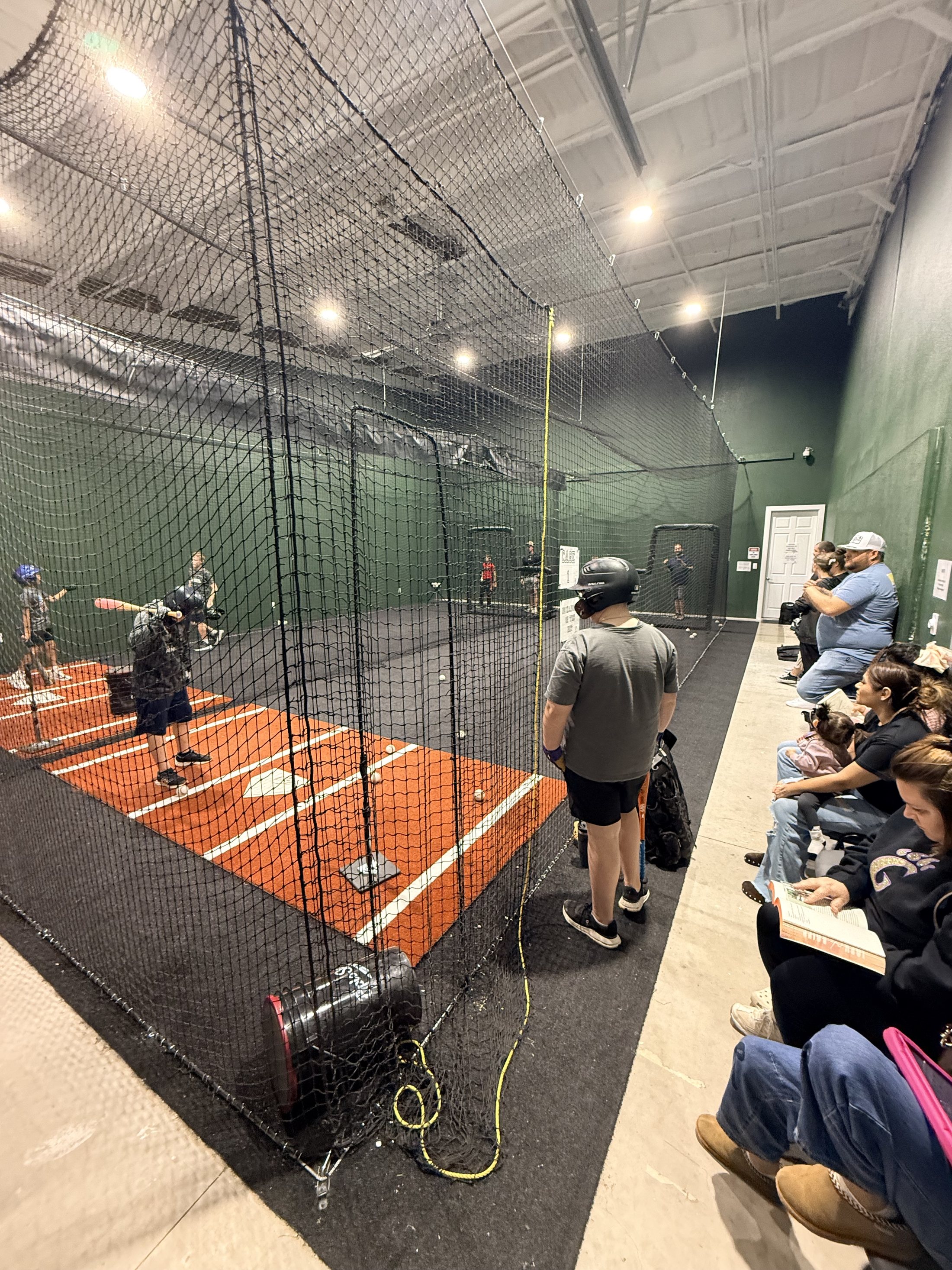 College baseball players training inside 4th Groove batting cages