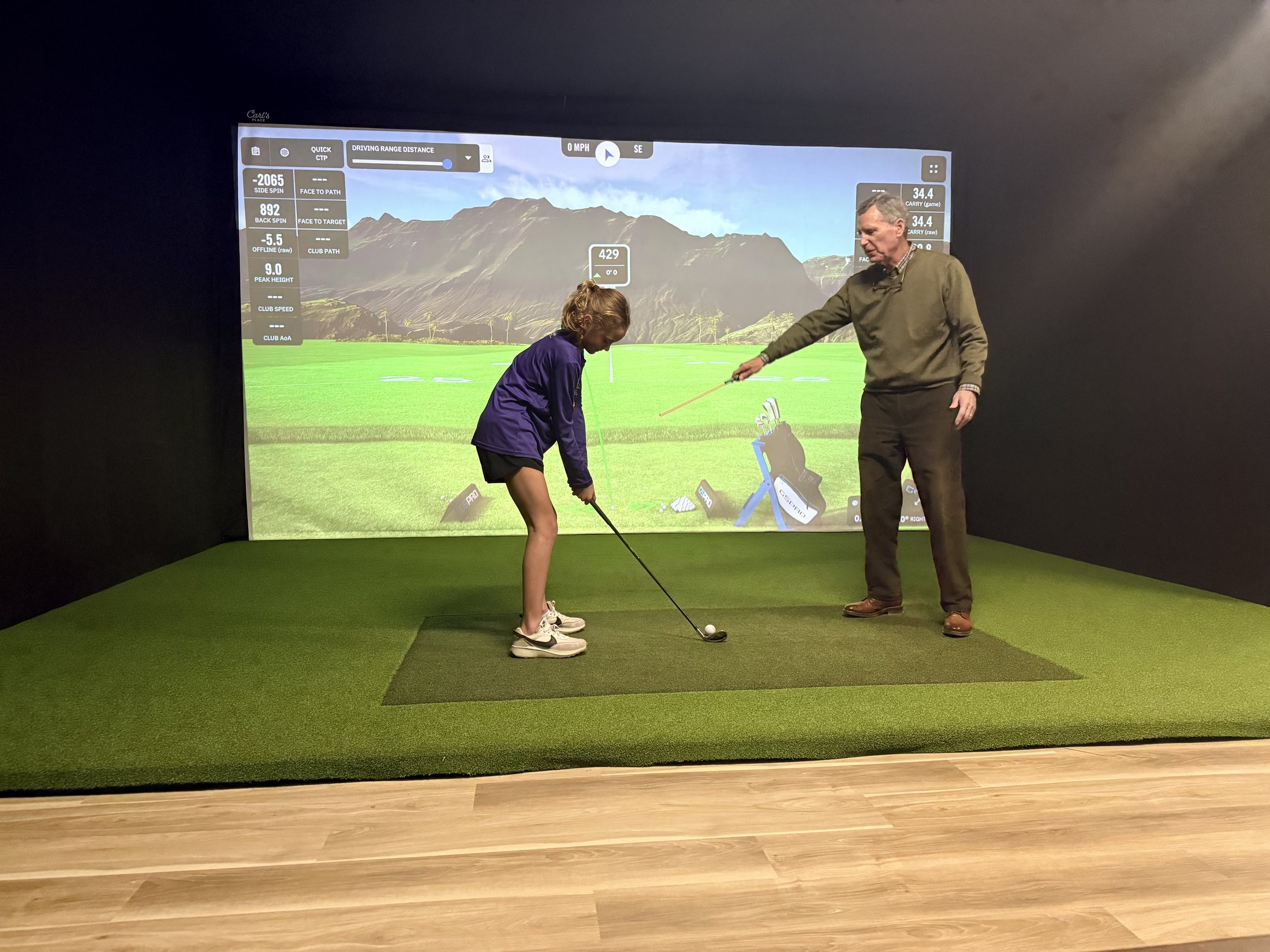 Golf lesson inside a 4th Groove simulator bay